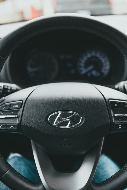 Free Focused view of a Hyundai steering wheel showcasing car interior and design details. Stock Photo