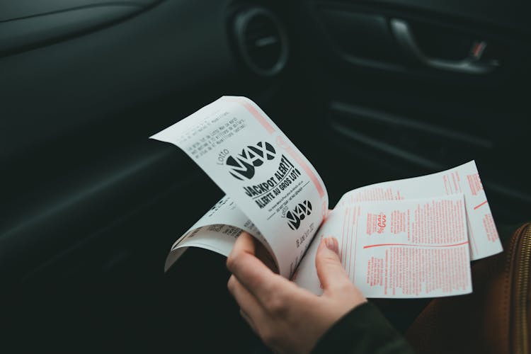 A Person Holding Lottery Tickets