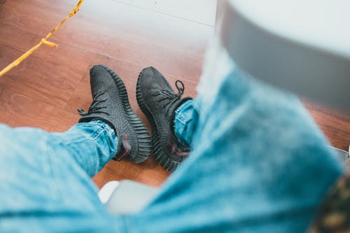 Free Person in Blue Denim Jeans Wearing Black Sneakers Stock Photo