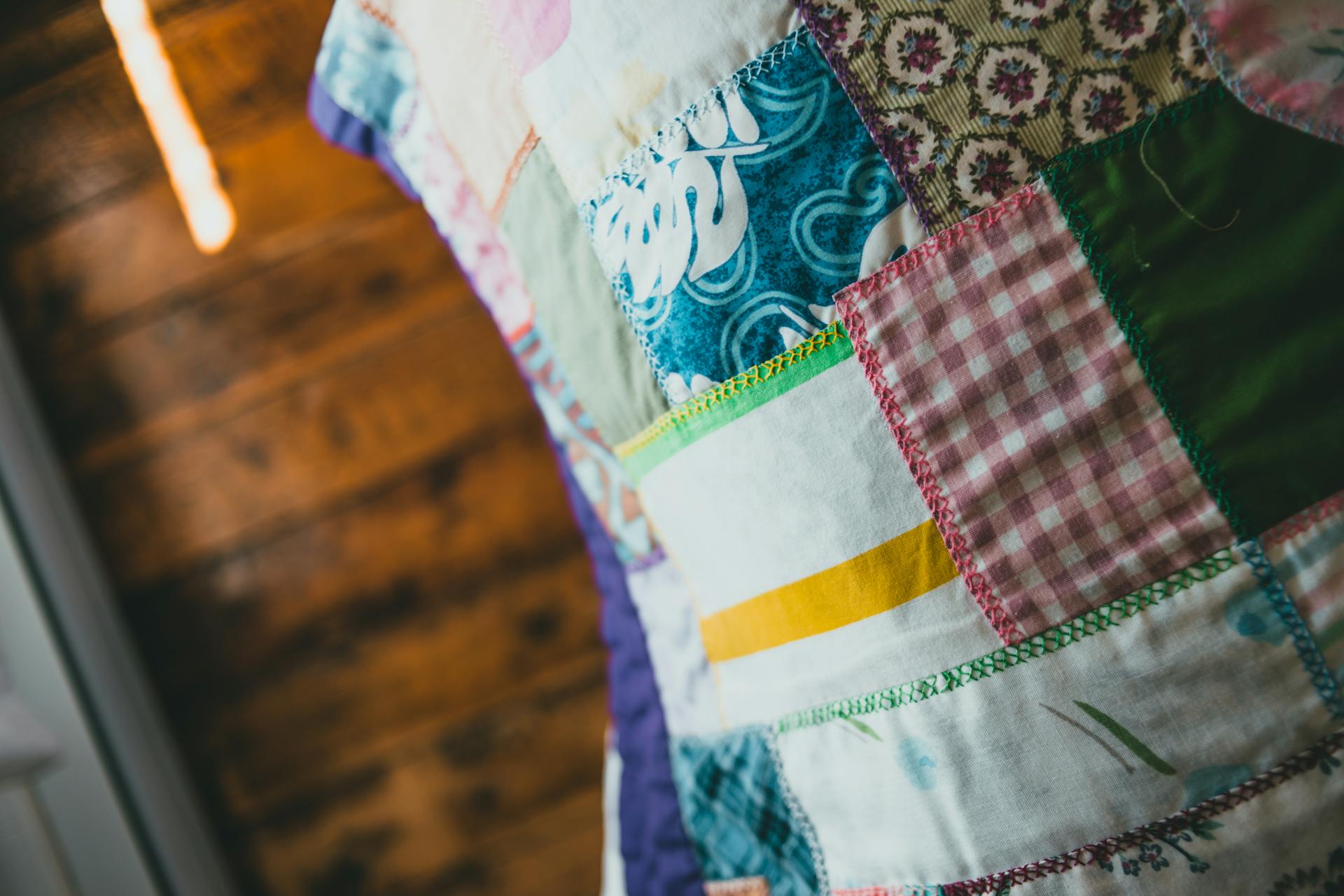 A close-up of a vibrant patchwork quilt showcasing various patterns and textures.