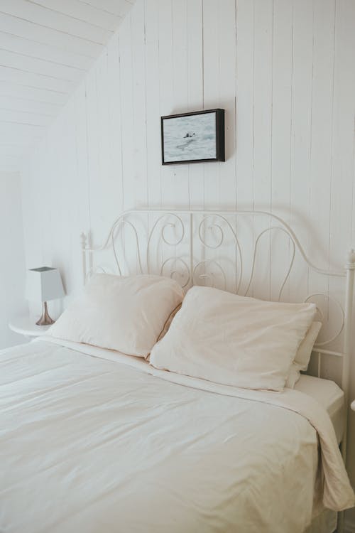 Free Bed with White Pillows and White Blanket Stock Photo