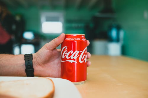 Close-up of Man Holding a Coca-Cola Can 