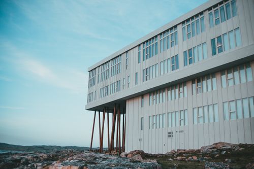 Free Striking modern building perched on rocky terrain in Newfoundland, showcasing innovative design. Stock Photo