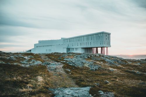 Free Fogo Island Inn's striking modern architecture set against a serene sunset backdrop. Stock Photo