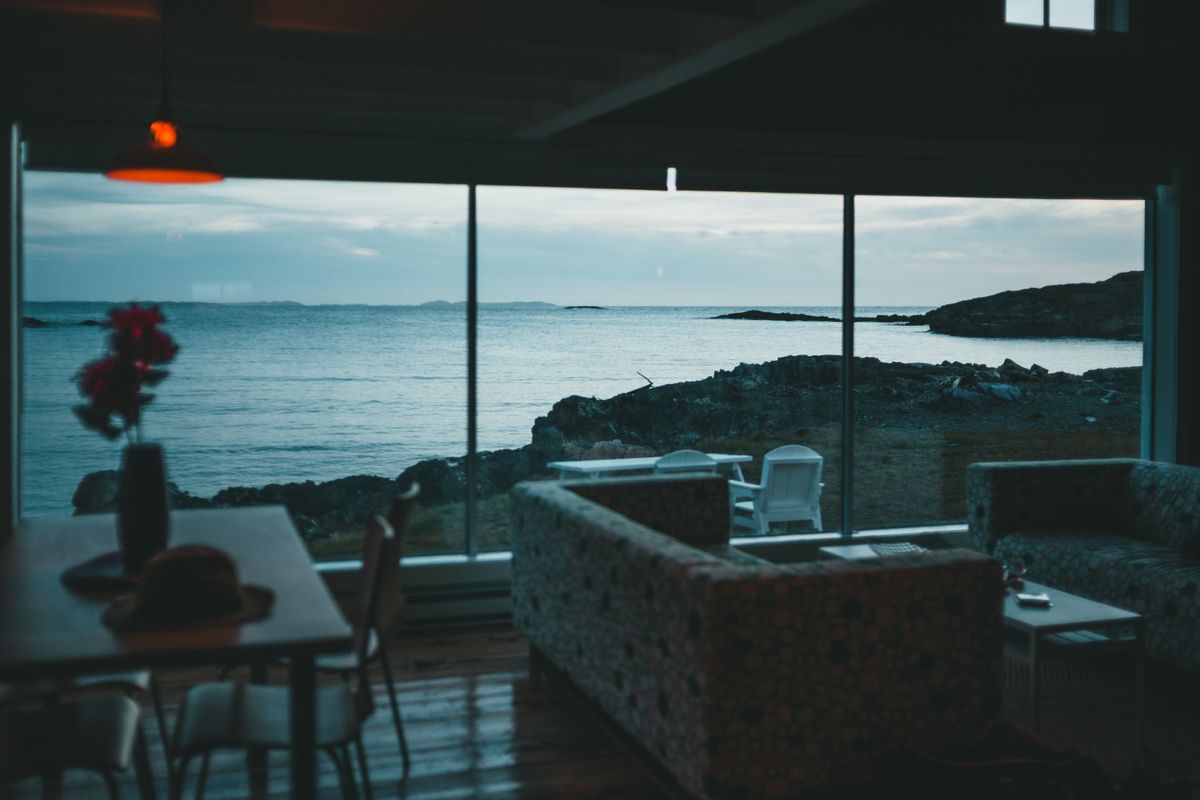 Cozy seaside sitting room with layered fabrics and ocean views