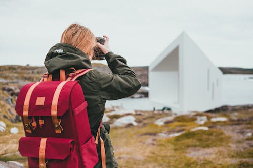 Woman in Black Jacket Taking Picture of White House