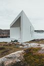 A Newly Built Tiny Concrete House Under White Clouds