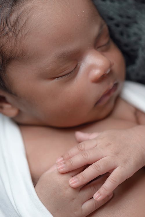 Free Baby Sleeping While Covered White Coat Stock Photo