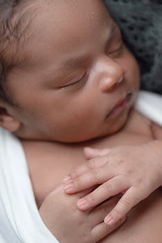 Baby Sleeping While Covered White Coat