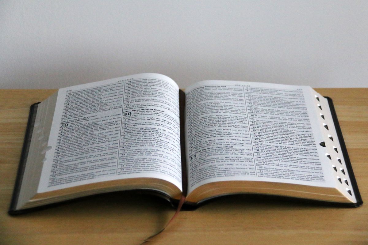 An open Bible, both pages facing — the Book agrees with itself
