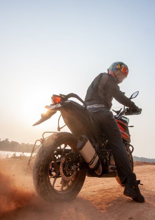 A Man in Riding a Black Motorcycle