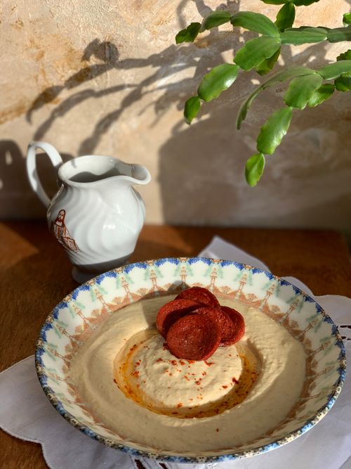 Free From above of delicious sweet dessert decorated with dried apricots in plate placed near milk jug on table Stock Photo