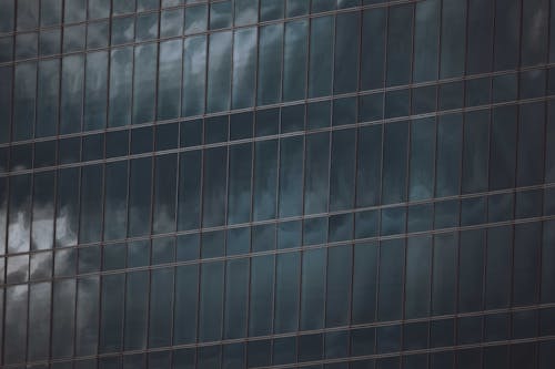 Close-up of a Glass Building Facade Reflecting the Sky 