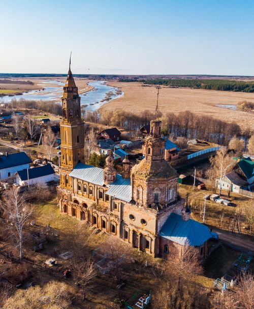 Free An aerial shot of an abandoned church amidst a rural landscape in Voskresenskaya Slobodka, Russia. Stock Photo