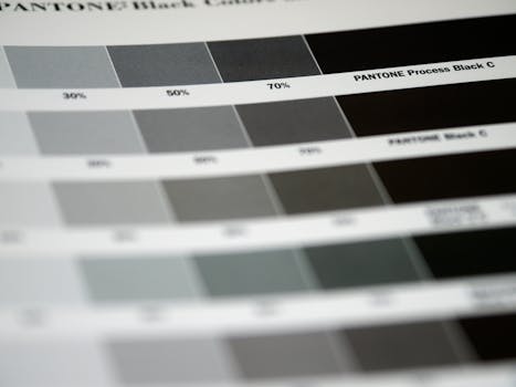 Detailed close-up of Pantone black color swatches, featuring various shades and percentages.