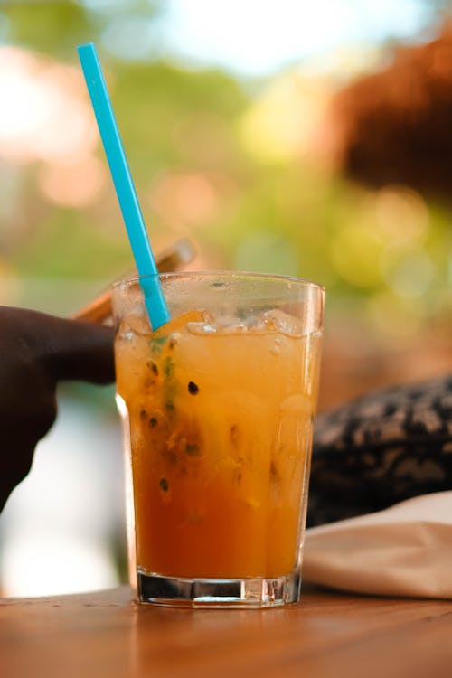 Close-Up Photo of a Beverage with a Blue Straw 