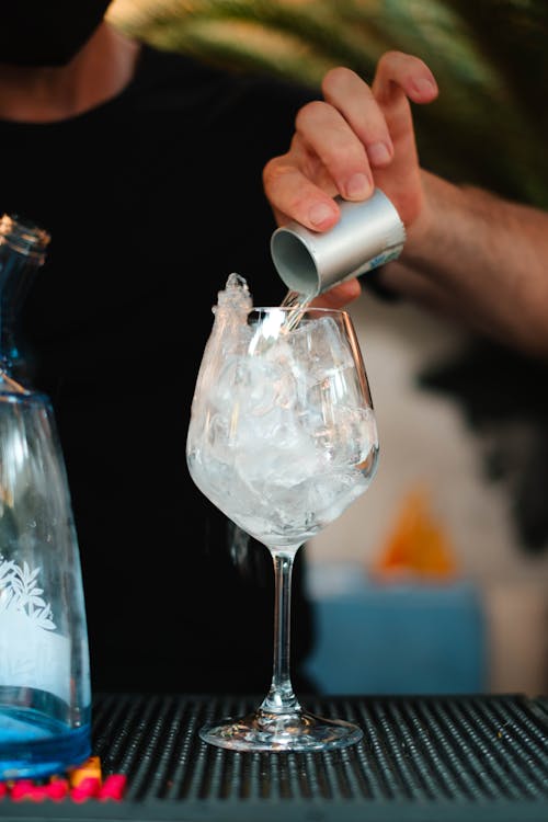 Bartender Pouring Alcohol into a Glass