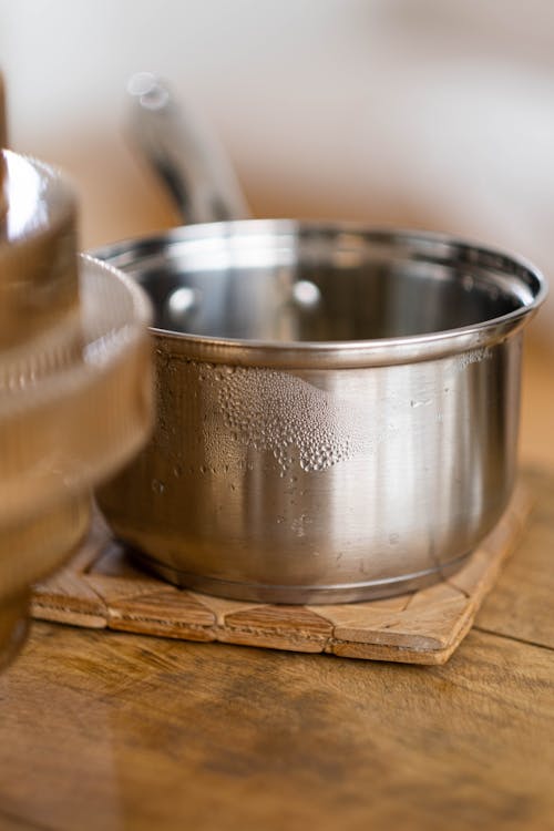 Stainless Steel Pot on Brown Wooden Board