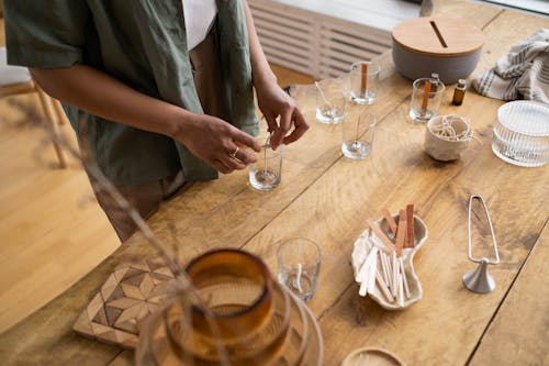 Clear Candle Glass on a Wooden Table