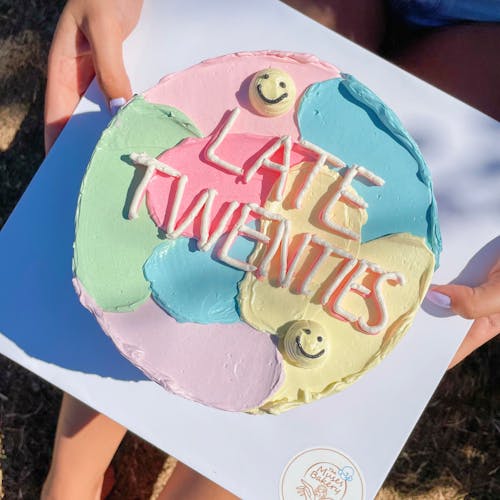 Close-Up Shot of a Person Holding a Birthday Cake