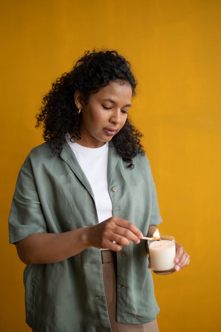 Woman Lighting A Candle