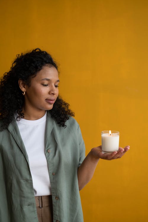 Free Woman Holding White Candle Light on a Glass Jar Stock Photo