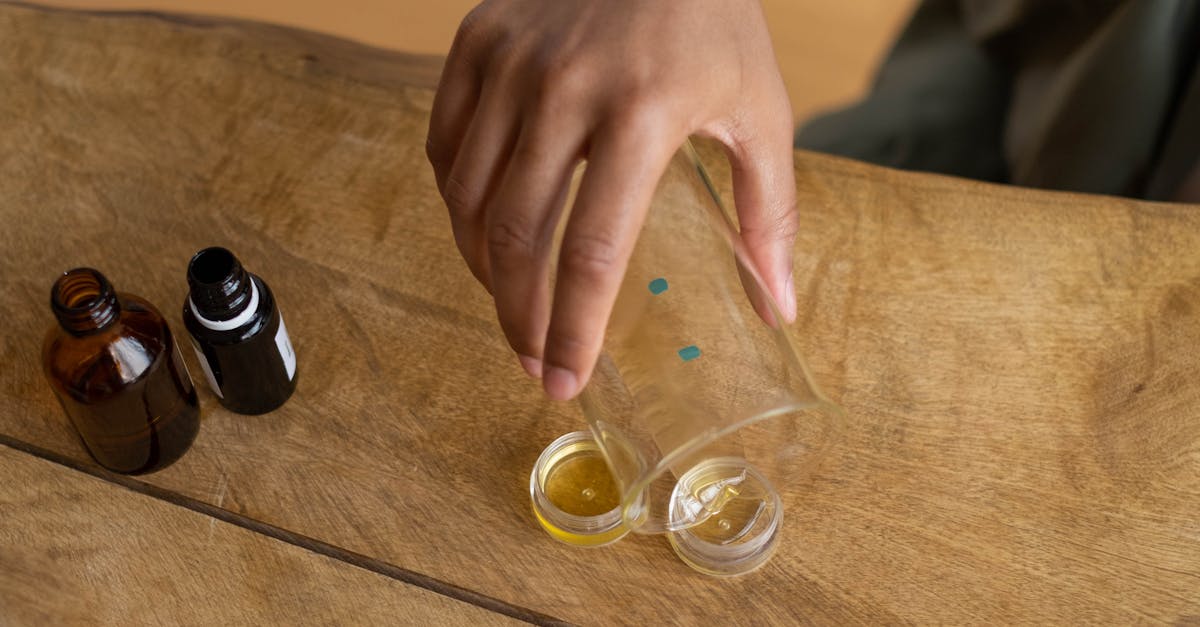 A person's hands holding a jar of homemade coconut oil moisturizer.
