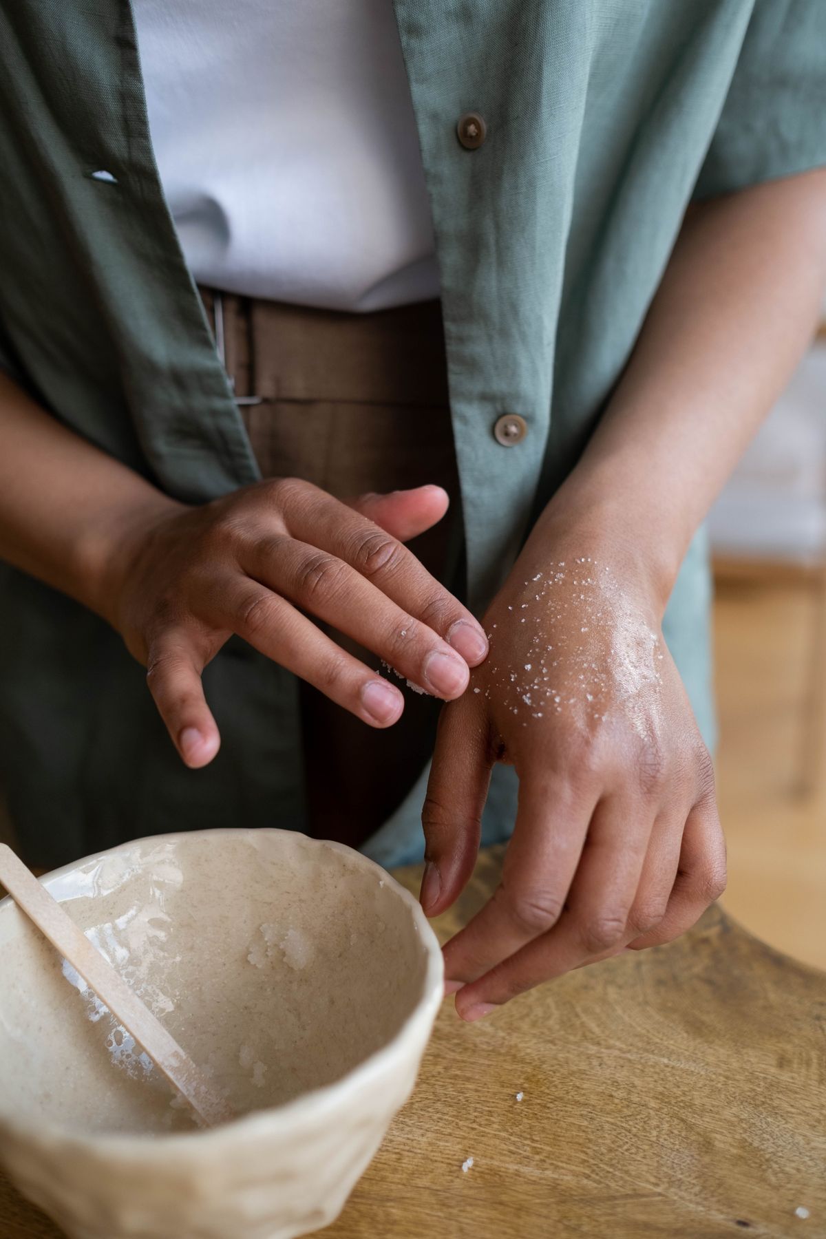 Applying lotion to dry skin irritated by hard water