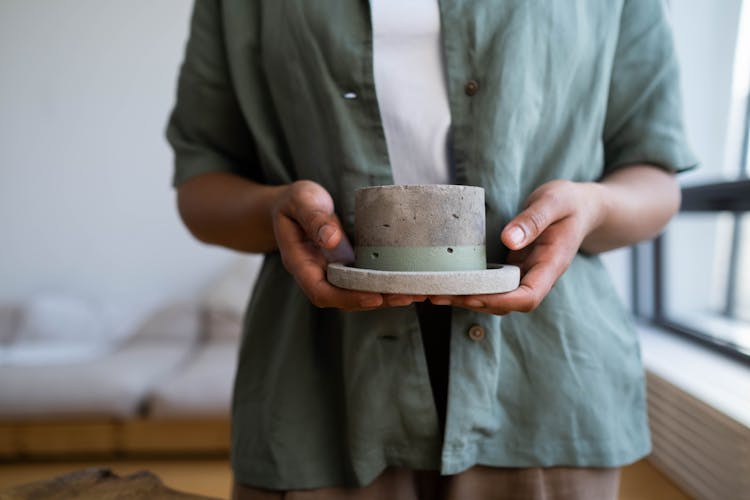 Close-up Of Holding A Stone Container