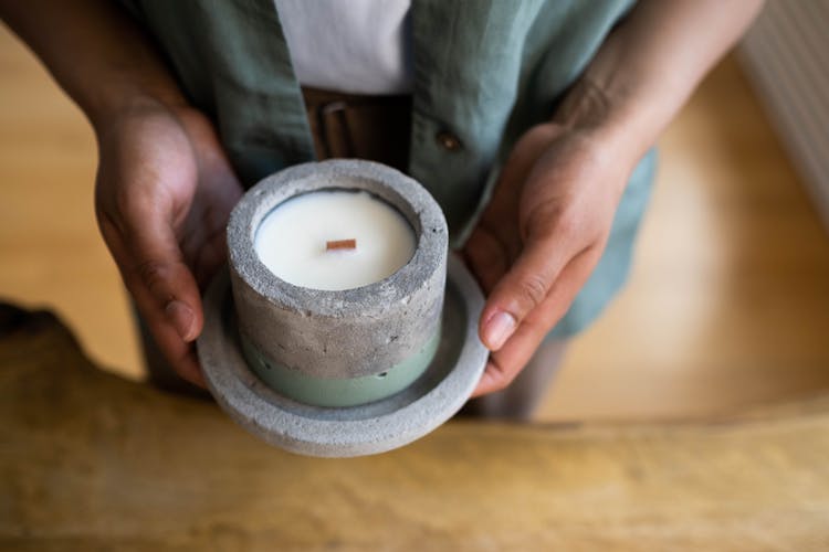 Close-up Of A Candle On Stone Container