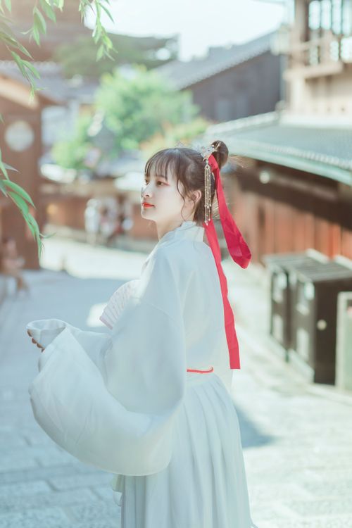 Free Woman in elegant traditional dress walking on a sunny historical street. Stock Photo