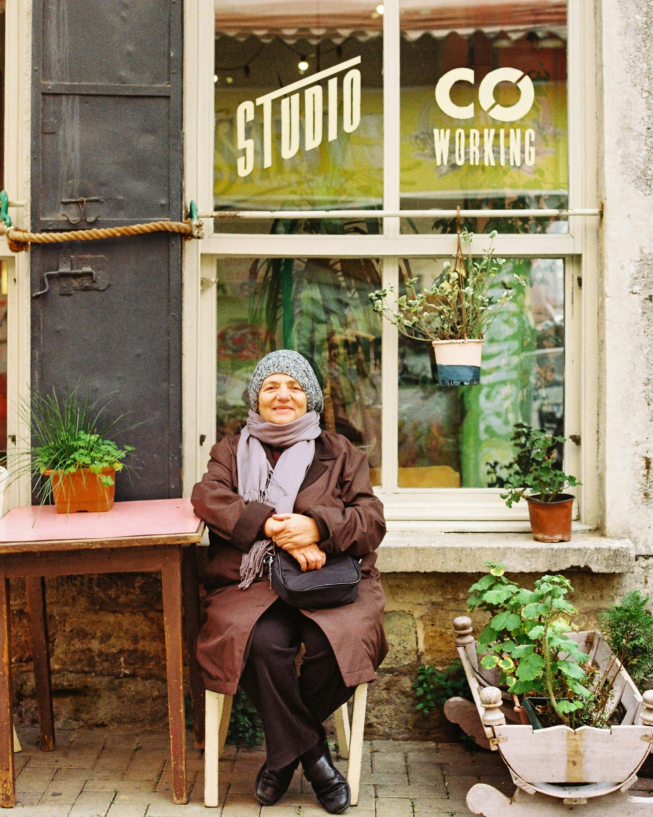 woman with a scarf sitting near plants