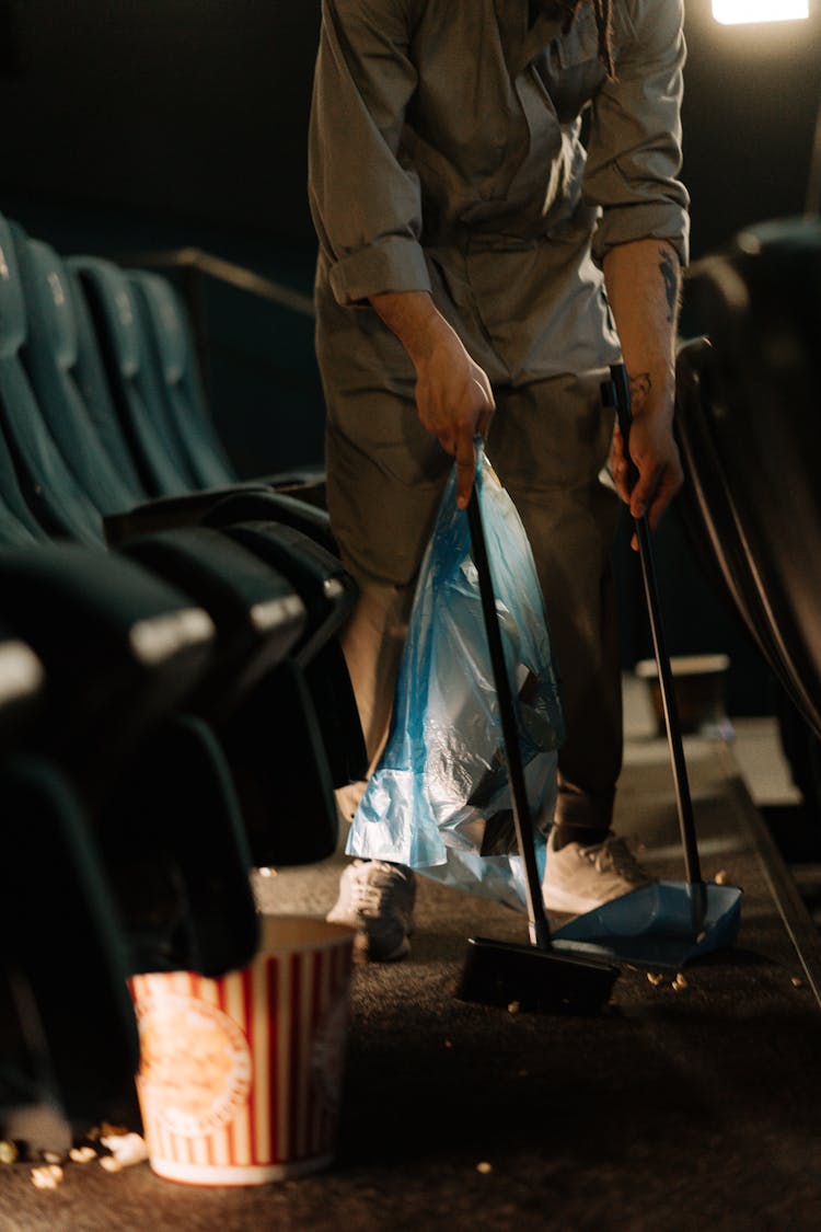 Person Sweeping Inside A Movie Theater