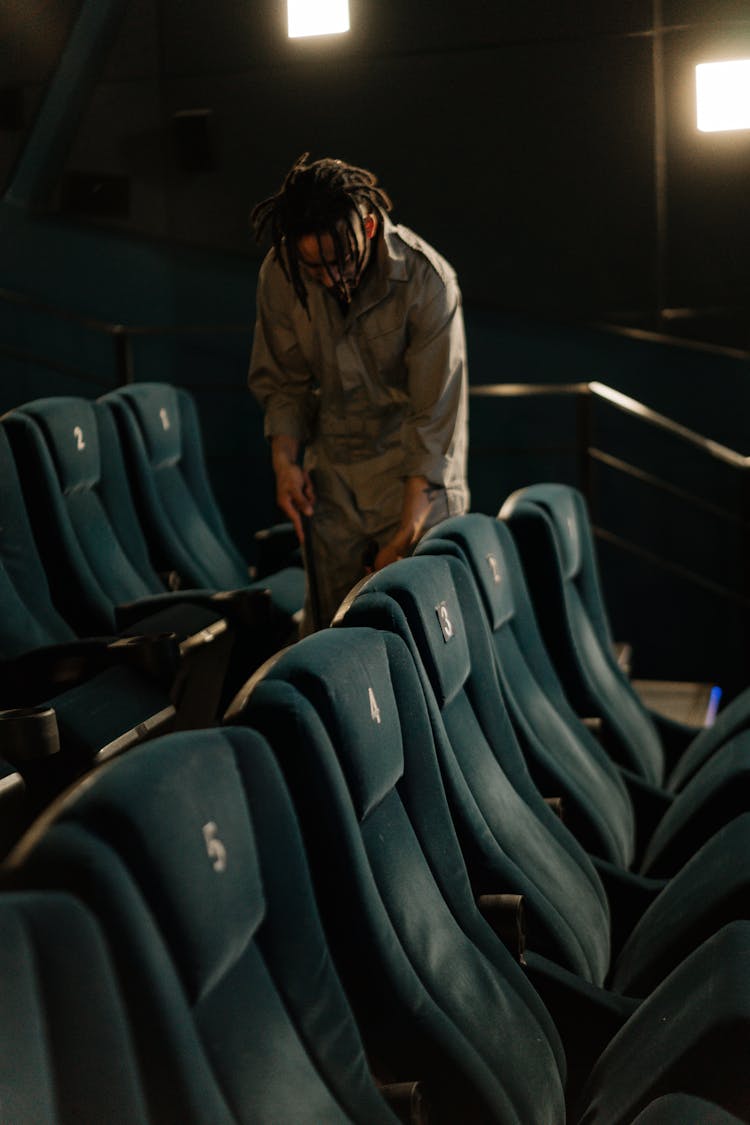 A Man Cleaning In A Movie Theater