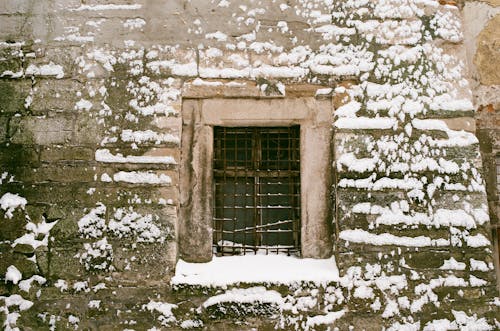 Window with Grill on a Concrete Wall