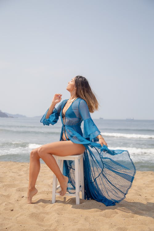 Free Woman in Black Bikini Sitting on a Stool at the Beach Stock Photo