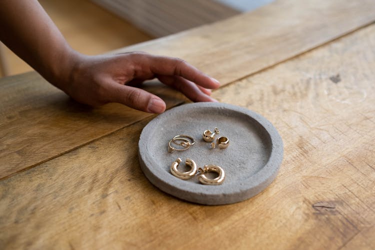 Gold Jewelries On A Round Flat Stone