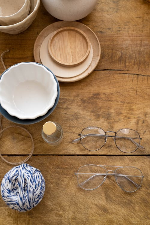 Silver Framed Eyeglasses on the Wooden Table