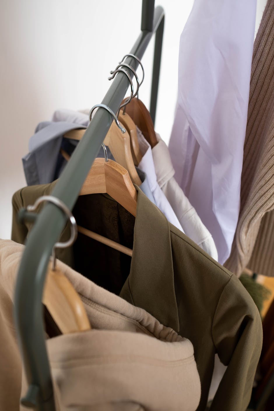 Stylish clothes hanging on a rack showcasing minimalist fashion design.
