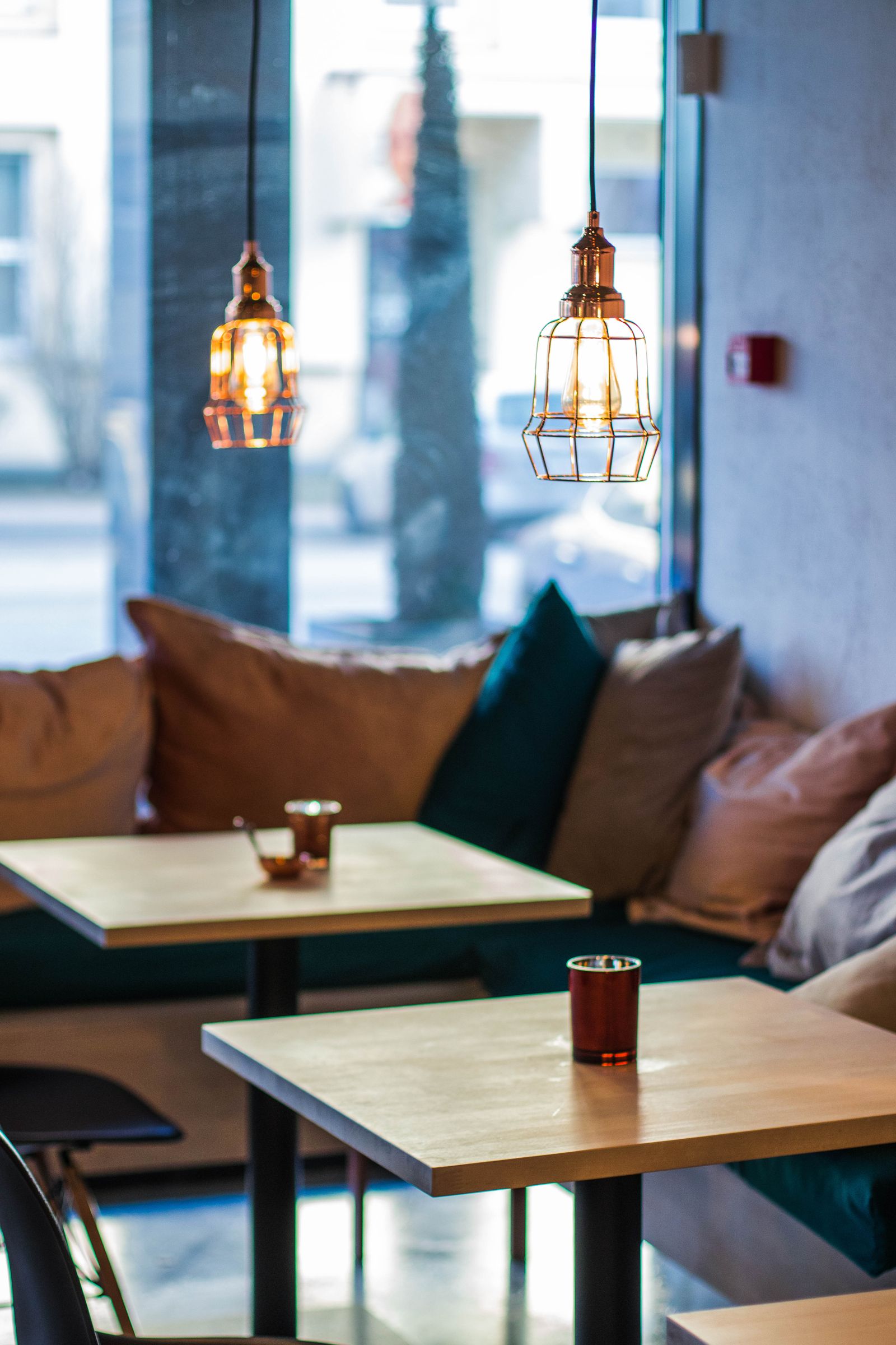 Warm restaurant seating area with pendant lighting