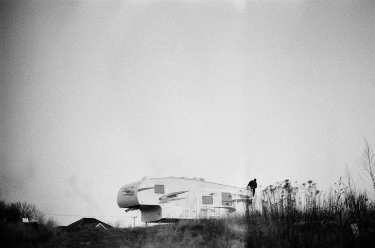 White Caravan Car On Green Grass Field