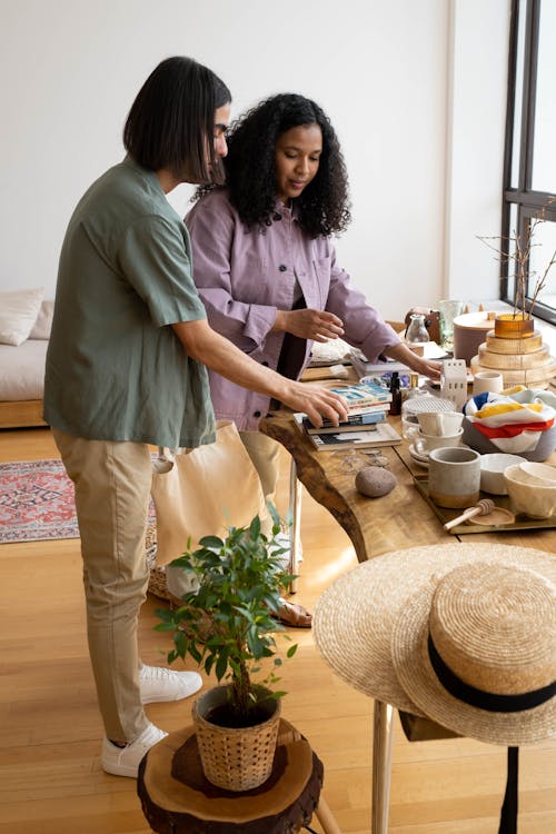 Woman and Man Standing by Table