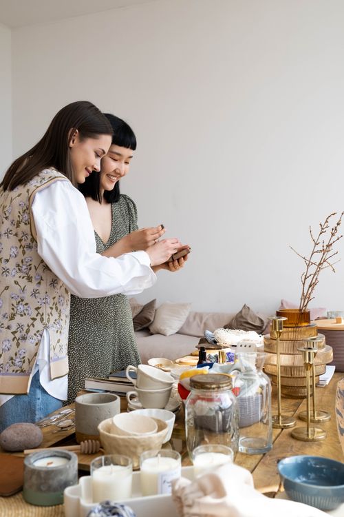 Free Two women enjoying a creative DIY project indoors. Various craft supplies around them. Stock Photo