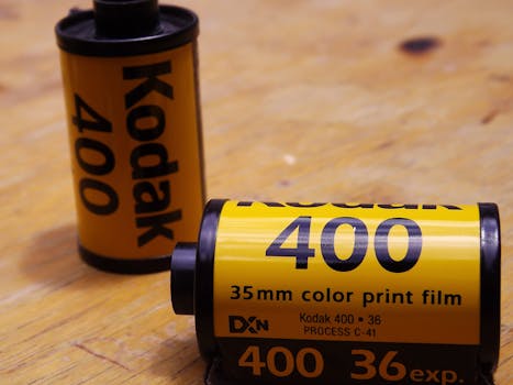 Close-up of Kodak 400 color print film rolls on a wooden surface.