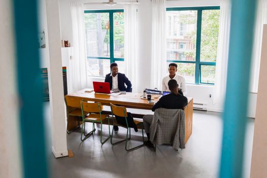 A professional meeting in a bright, modern office with business people collaborating.