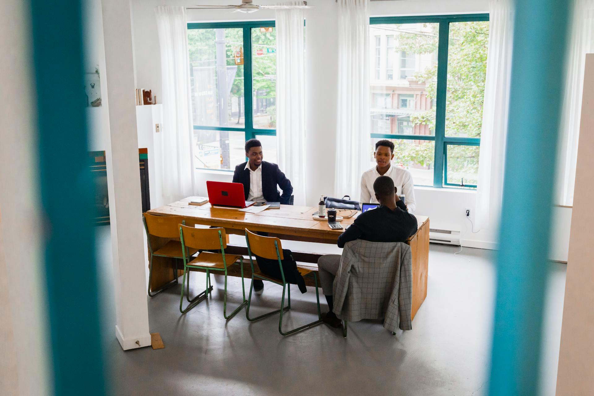 A professional meeting in a bright, modern office with business people collaborating.