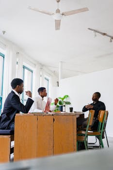 Three men discussing business strategies in a bright office setting.