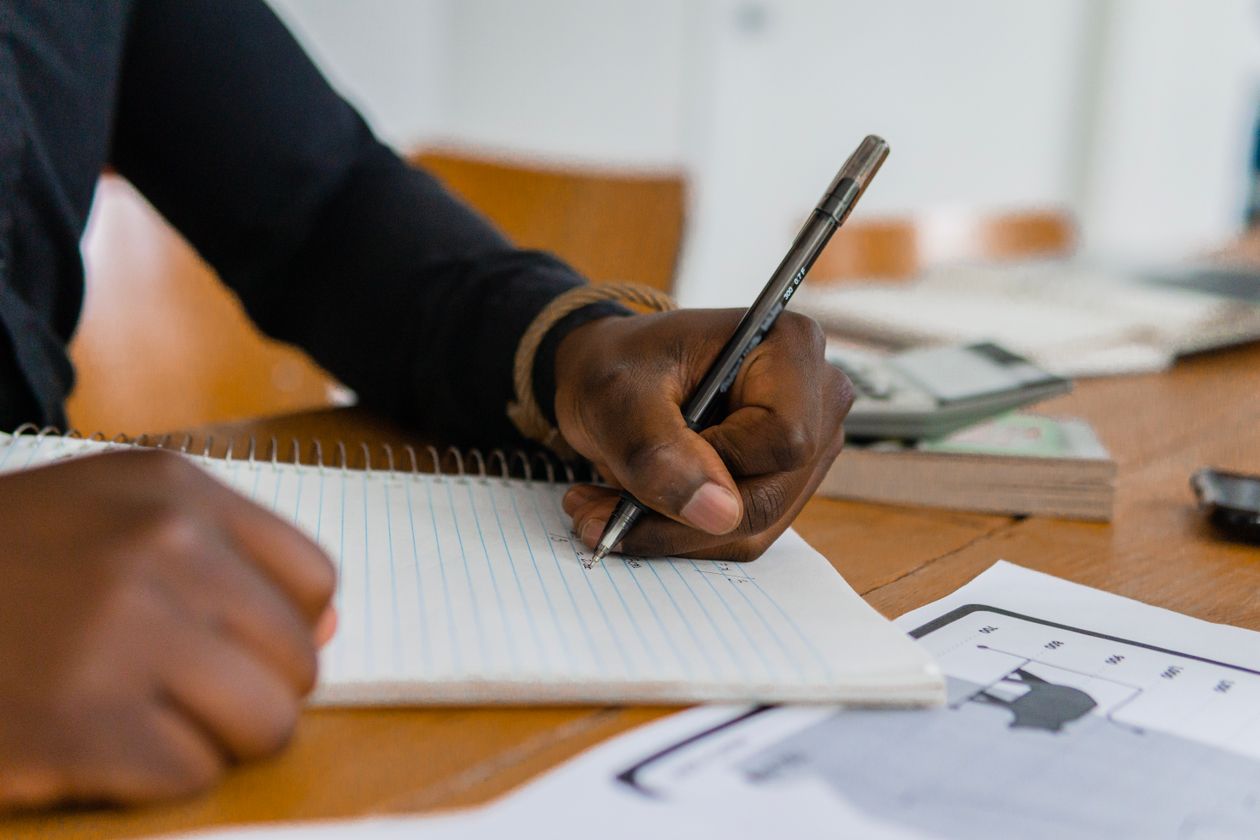 Person writing left-handed at a desk — left-handed fountain pen writing