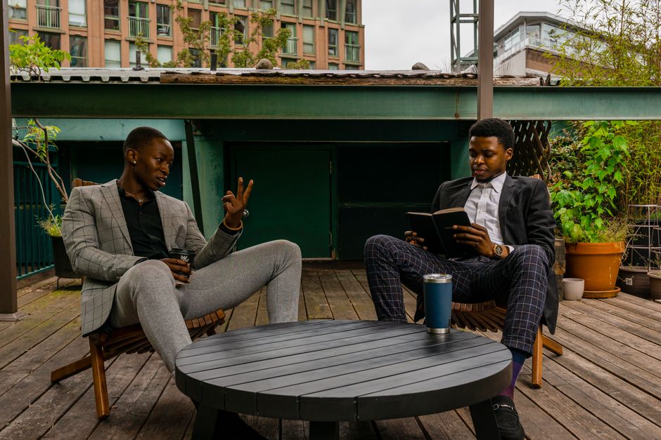 Two businessmen discussing business strategies in a relaxed outdoor setting.