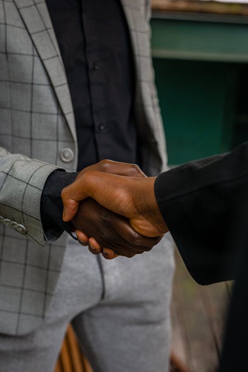 Close-Up Shot of Two People Shaking Hands